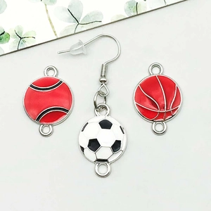 Macro detail of enamel sport charms featuring football and basketball alloy pendants