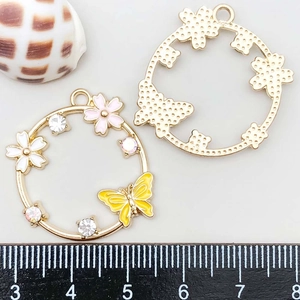 Macro view of 30mm colorful enamel butterfly flower charm with rhinestone details