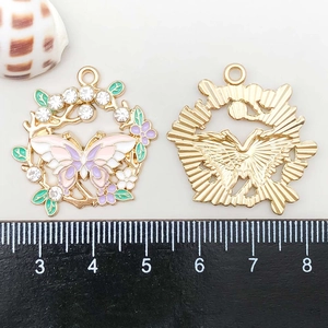 Macro shot of colorful enamel butterfly wreath pendant with rhinestones and gold alloy base
