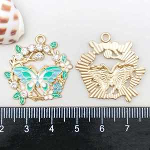 Detailed front and back view of a colorful butterfly pendant with measurement ruler