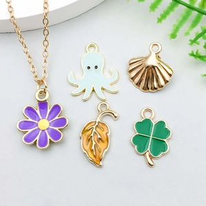 Detail view of colorful enamel star moon charms and pendants for DIY jewelry making