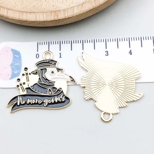 Macro detail of enamel plague doctor charm with No more germs text and ruler scale