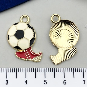 Detailed macro view of soccer ball and cleat charms with gold alloy back and measurements