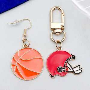 Detail of enamel basketball earring and red rugby helmet keychain sports charms