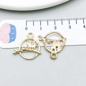 Macro shot of 1.8cm golden cat on branch alloy pendant for DIY jewelry making