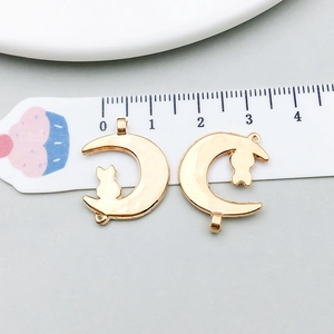 Detail of 22mm gold-plated crescent moon and cat alloy charms for DIY jewelry