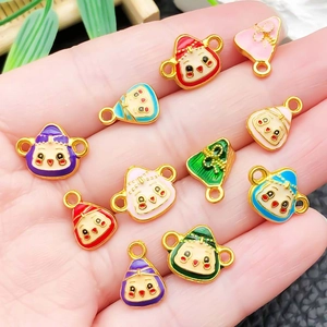 Bunte Emaille-Anhänger mit Affengesicht und Zongzi-Form für DIY-Schmuck in der Hand