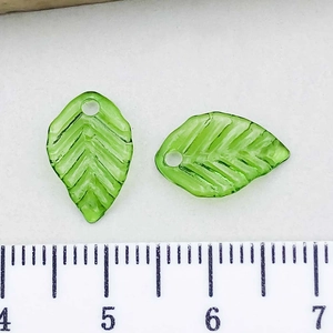 Close-up of green transparent leaf charms with veins and size scale measurement