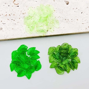 Macro view of transparent acrylic leaf pendants with detailed vein patterns for DIY jewelry