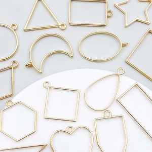 Detailed view of hollow geometric moon and star alloy frame pendants for DIY jewelry