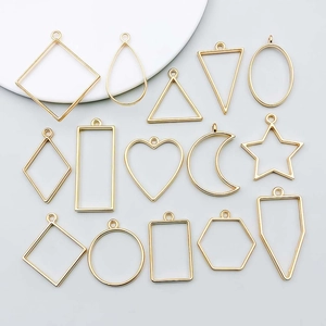 Close-up of 14 assorted gold geometric alloy moon and star pendants for DIY jewelry making