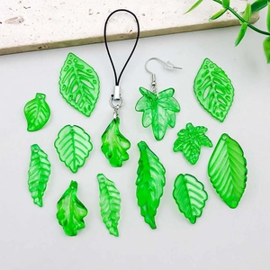 Macro detail of assorted green translucent acrylic leaf charms with vein textures for DIY