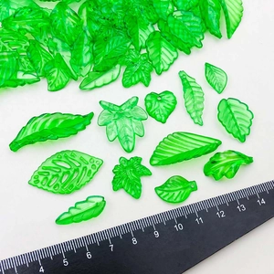 Assorted green acrylic leaf charms in various shapes for DIY jewelry making