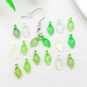 Close-up of green leaf acrylic pendants with detailed vein texture for DIY jewelry