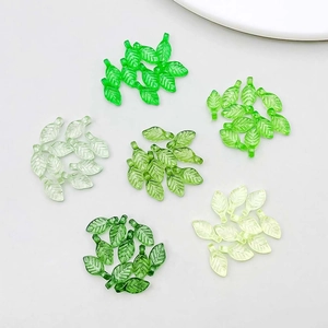 Macro detail of leaf-shaped acrylic pendants with gradient green colors and clear vein texture