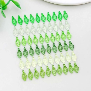 Detailed grid of 60 green acrylic leaf charms with pre-drilled holes for DIY jewelry
