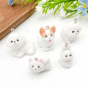 Detailed close-up of fuzzy flocked resin animal pendants for DIY jewelry making charms