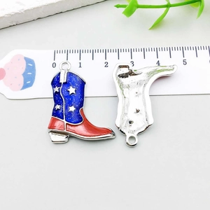Detail of cowboy boot pendant with American flag pattern and blue enamel finish