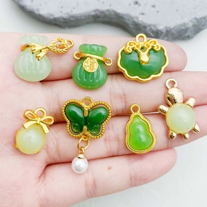 Green glass jade pendants with gold frames featuring traditional Chinese fortune motifs