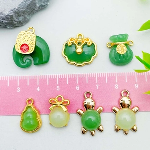 Green glass ingot pendants in jade style with gold edges and varied lucky symbols