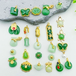 Green faux jade pendants set with gold-plated Chinese lucky charms and animal motifs