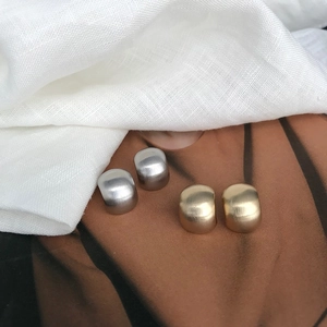Minimalist U-shaped brushed metal stud earrings in gold and silver finishes