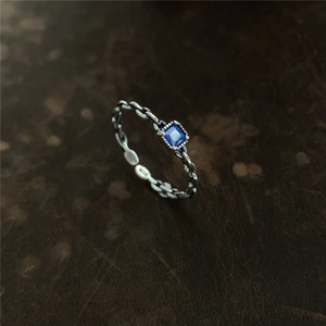 Macro d'une bague chaîne en argent S925 avec zircon bleu carré et poinçon gravé