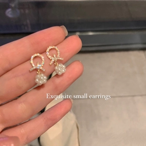 Bow knot earrings with inlaid diamonds and white pearl clusters for a refined look