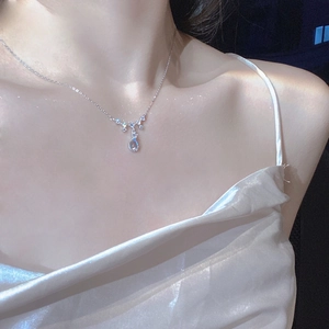 925 silver moonstone teardrop necklace shown on neck with elegant crystal pendant