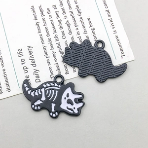 Detail view of black and white enamel dinosaur fossil pendant with textured metal back