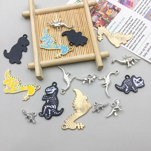 Detail of colorful dinosaur alloy charms with floral patterns for DIY jewelry making