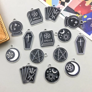 Detailed view of gothic spellbook and celestial charms for DIY jewelry making