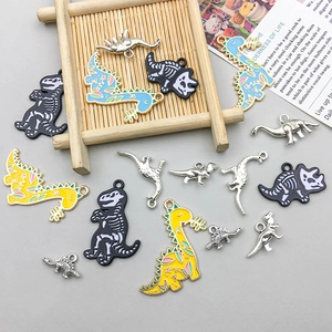 Detailed macro view of assorted enamel dinosaur charms for DIY jewelry making and crafts