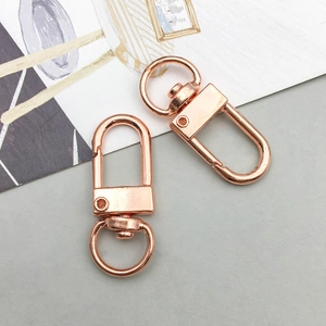 Detail shot of two rose gold lobster claw clasps with 360-degree swivel rings