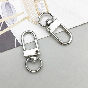 Close-up of two silver metal swivel lobster clasps for DIY jewelry and bag hardware