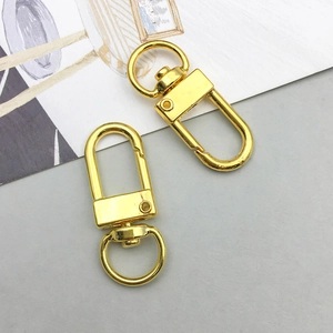Detailed view of two gold metal lobster clasps with swivel rings for DIY jewelry projects