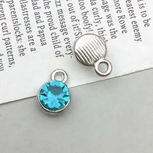 Detailed macro view of light blue crystal pendants with silver alloy base for DIY jewelry