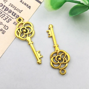 Macro detail of antique gold rose key pendant with embossed texture for DIY jewelry