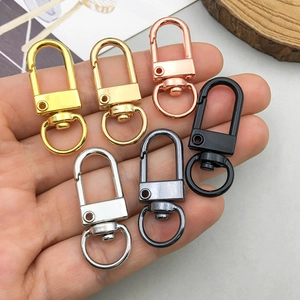 Handheld set of six colorful metal lobster clasps with 360-degree swivel rings