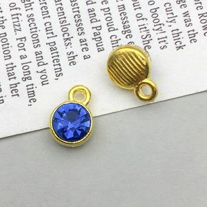 Detailed macro view of front and back of round blue rhinestone pendant for DIY jewelry