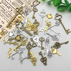 Macro view of vintage alloy key pendants in bronze, silver, and gold for DIY jewelry