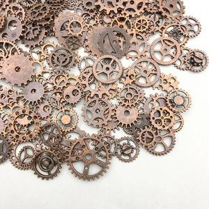 Detail showing vintage bronze gear charms collection for steampunk DIY jewelry making