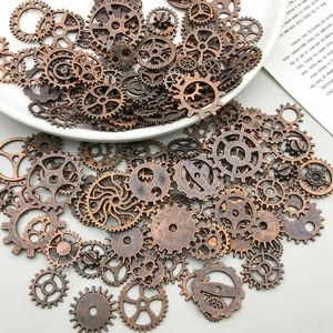 Macro shot of assorted bronze steampunk gear pendants and mechanical clock parts for DIY crafts