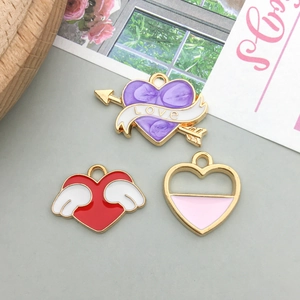 Detailed view of colorful alloy heart and wing pendants for DIY jewelry making