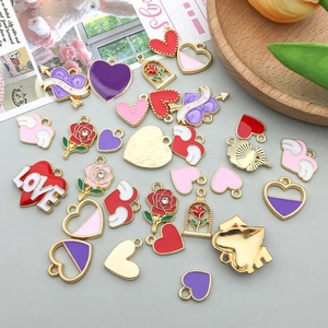 Macro shot of colorful enamel heart and rose charms for DIY jewelry making