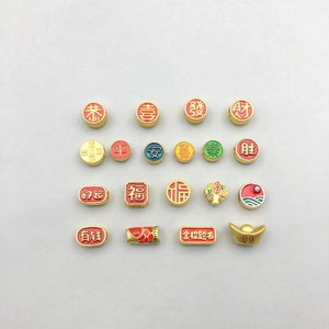 Flat lay of 20 Chinese New Year pendants with colorful enamel and golden lucky symbols