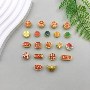 Macro detail of red enamel and golden Chinese New Year lucky charm jewelry pendants