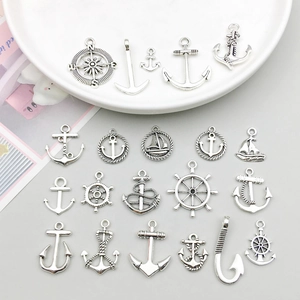Detail of vintage silver nautical charms including anchors and rudders for DIY jewelry