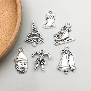 Antique silver Christmas charms set featuring Santa, tree, and bells for DIY jewelry