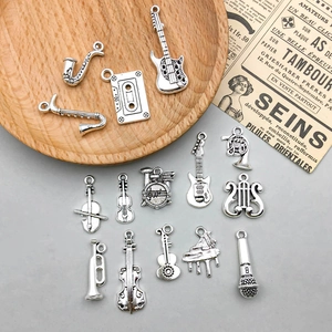 Macro view of vintage silver musical instrument alloy charms for DIY jewelry making